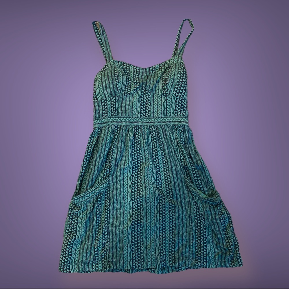 Strap back, mini dress flower with pockets in the front